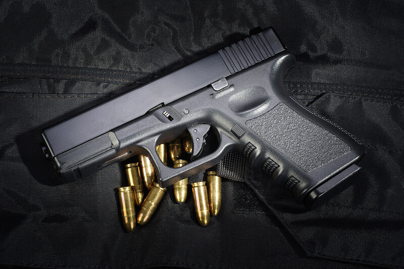 Homepage 34 handgun laying on table with bullets